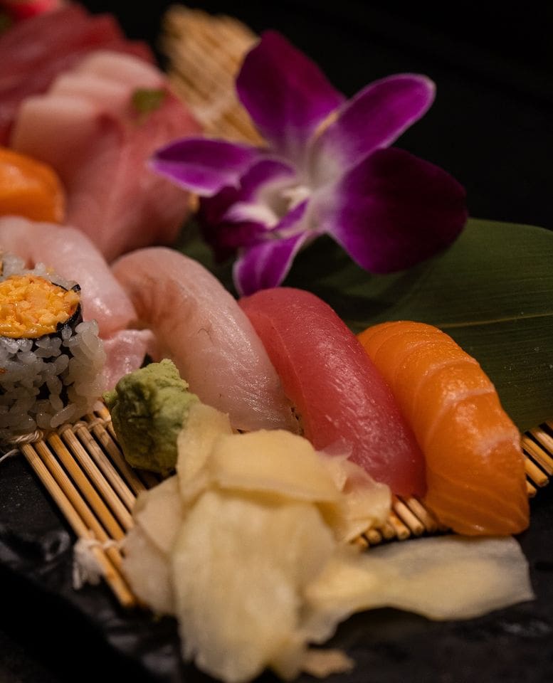 A plate of sushi and other food on a table.