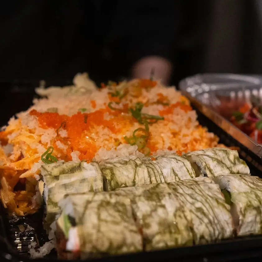 A tray of food with rice and vegetables on it.