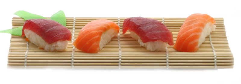 Two pieces of sushi are sitting on a bamboo mat.